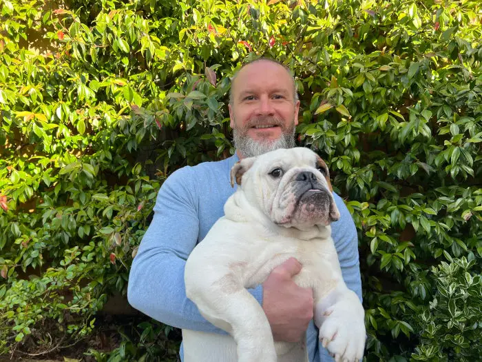 Brett Ray, Richmond Futures' Party Wall Surveyor holding up his dog.